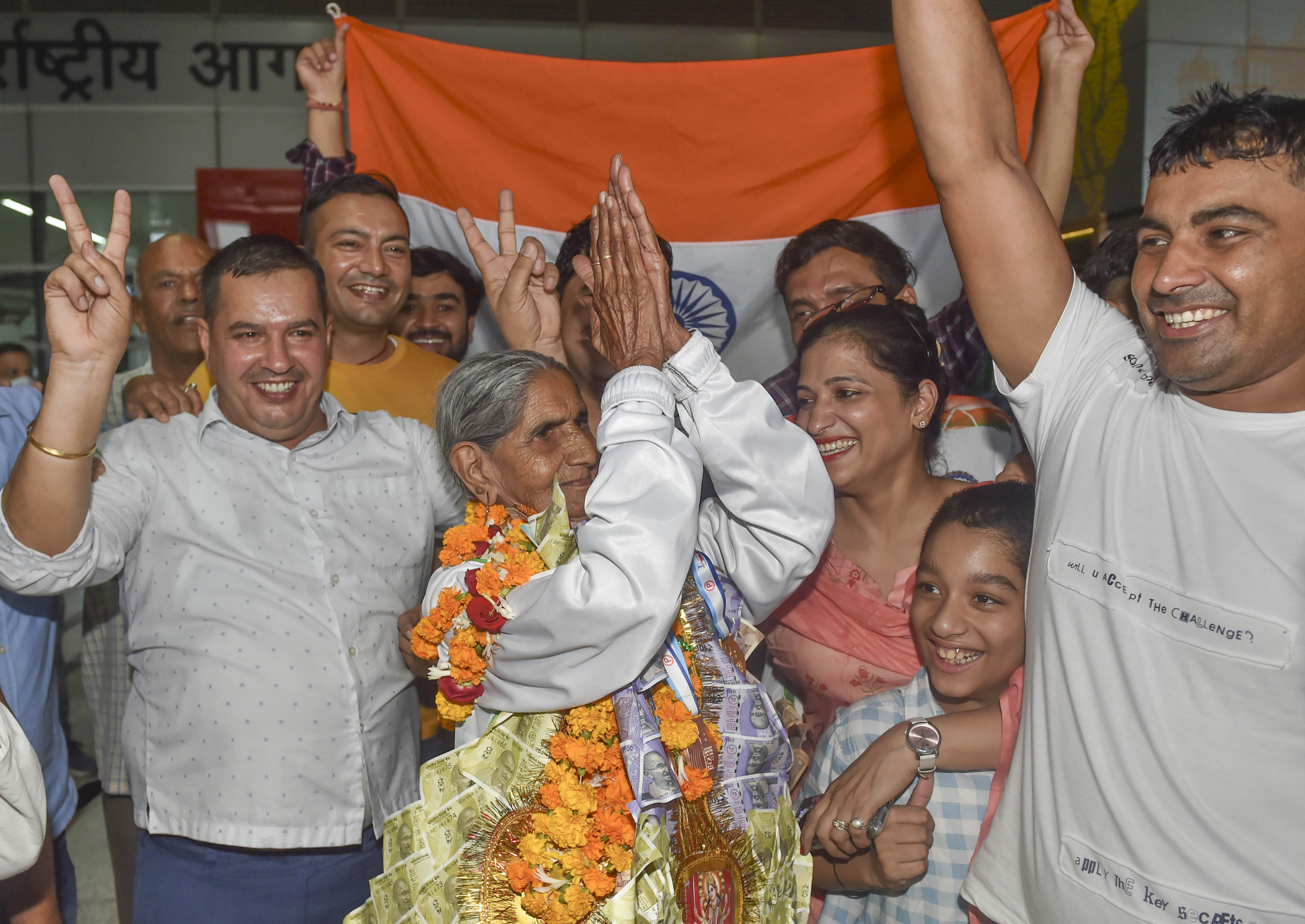 Bhagwani Devi Dagar dances as her relatives and family members applaud, after her arrival at IGI Airport in Delhi, (PTI) Bhagwani Devi Dagar dances as her relatives and family members applaud, after her arrival at IGI Airport in Delhi, (PTI)