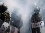 Members of the police stand guard during a protest outside the office of Sri Lanka's Prime Minister Ranil Wickremesinghe, amid the country's economic crisis, in Colombo. (REUTERS/Adnan Abidi)