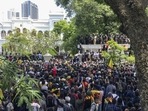 Sri Lankan protesters storm prime minister Ranil Wickremesinghe 's office, demanding he resign after president Gotabaya Rajapaksa fled. (AP Photo/Rafiq Maqbool)