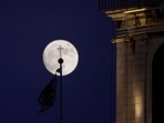 The waxing gibbous moon rises behind a cross at a church in the old city of JerusalemoOn July 12, 2022, a day ahead of the July The waxing gibbous moon rises behind a cross at a church in the old city of JerusalemoOn July 12, 2022, a day ahead of the July
