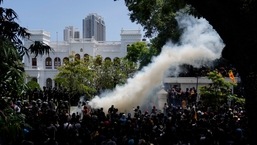 Police use teargas as Sri Lankan protesters storm the compound of prime minister Ranil Wickremesinghe's office, (AP Photo/Rafiq Maqbool)