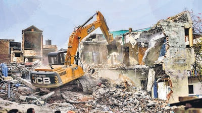 A bulldozer being used to demolish the ‘illegally constructed’ house of an accused in Prayagraj violence in June. (PTI) A bulldozer being used to demolish the ‘illegally constructed’ house of an accused in Prayagraj violence in June. (PTI)