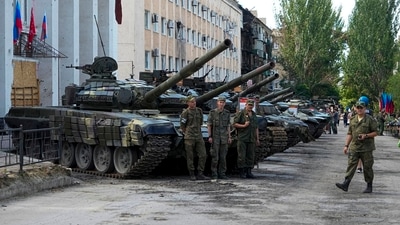 Luhansk People's Republic people militia servicemen stand at an exhibition of captured Ukrainian tanks and weapons in Lisichansk. (AP) Luhansk People's Republic people militia servicemen stand at an exhibition of captured Ukrainian tanks and weapons in Lisichansk. (AP)