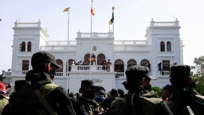 Security personnel stand guard as demonstrators enter the building of the office of Sri Lanka's Prime Minister Ranil Wickremesinghe, amid the country's economic crisis, in Colombo.&nbsp; (Reuters)