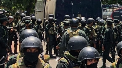 Army soldiers stand guard during an anti-government protest by demonstrators outside the office of Sri Lanka's prime minister in Colombo. (AFP)