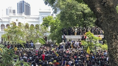 Sri Lankan protesters storm prime minister Ranil Wickremesinghe 's office, demanding he resign after president Gotabaya Rajapaksa fled. (AP Photo/Rafiq Maqbool)