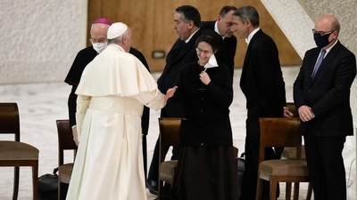 Pope Francis shakes hands with Sister Raffaella Petrini, secretary general of the Vatican's governorship, as he arrives for an audience with employees in the Paul VI Hall, at the Vatican. (AP) Pope Francis shakes hands with Sister Raffaella Petrini, secretary general of the Vatican's governorship, as he arrives for an audience with employees in the Paul VI Hall, at the Vatican. (AP)