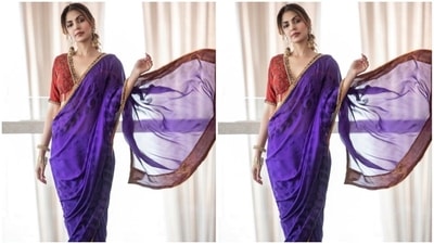 Rhea teamed the purple saree with a heavily embroidered blouse in a contrasting red shade. It features a plunging V neckline adorned with a patti border, intricate handiwork on the torso, half sleeves, and a back cut-out with tassel-adorned ties. (Instagram)