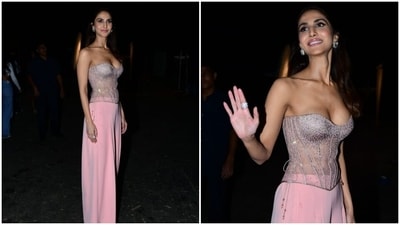 Vaani accompanied Ranbir for the promotional event in a blush pink ensemble. She wore a strapless corset top featuring a plunging sweetheart neckline flaunting her decolletage, silver embellishments, see-through panels on the midriff, and structured boning to accentuate her curves. (HT Photo/Varinder Chawla)