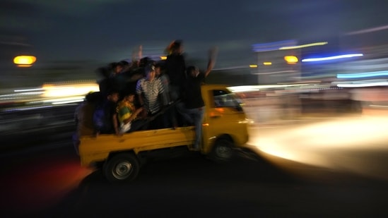 Protesters arrive in a mini truck to join others during clashes with police near parliament in Colombo, Sri Lanka.(AP)