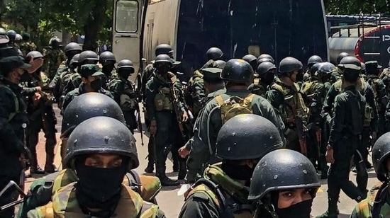 Army soldiers stand guard during an anti-government protest by demonstrators outside the office of Sri Lanka's prime minister in Colombo.(AFP)