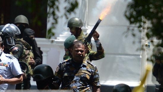 Sri Lanka crisis: An army personnel fires a tear gas canister to disperse demonstrators during an anti-government protest outside the office of Sri Lanka's prime minister in Colombo.(AFP)