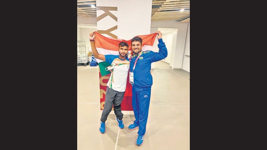 Praveen Kumar with his coach, Satpal Singh.