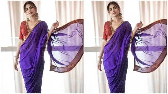 Rhea teamed the purple saree with a heavily embroidered blouse in a contrasting red shade. It features a plunging V neckline adorned with a patti border, intricate handiwork on the torso, half sleeves, and a back cut-out with tassel-adorned ties.(Instagram)