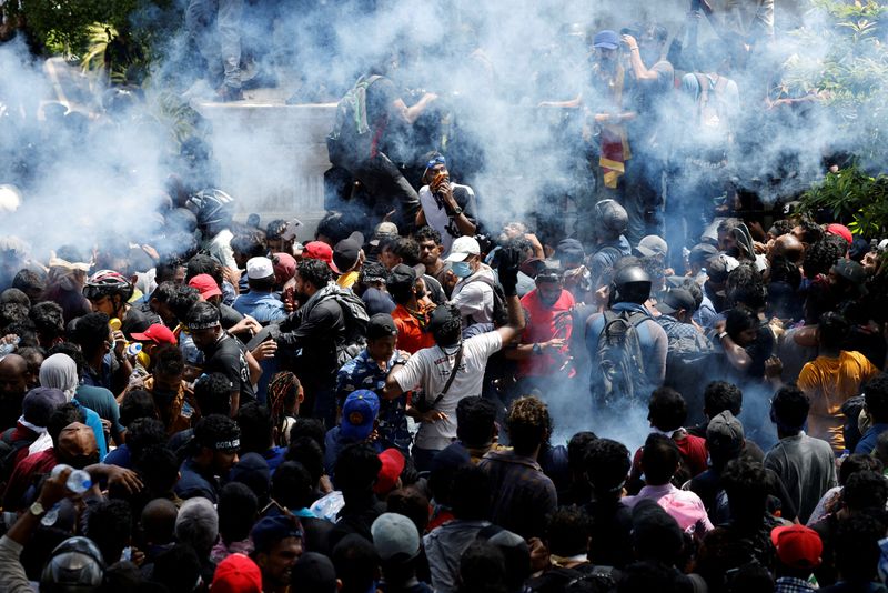 Demonstrators gather outside the office of Sri Lanka's Prime Minister Ranil Wickremesinghe in Colombo on Wednesday. (REUTERS)