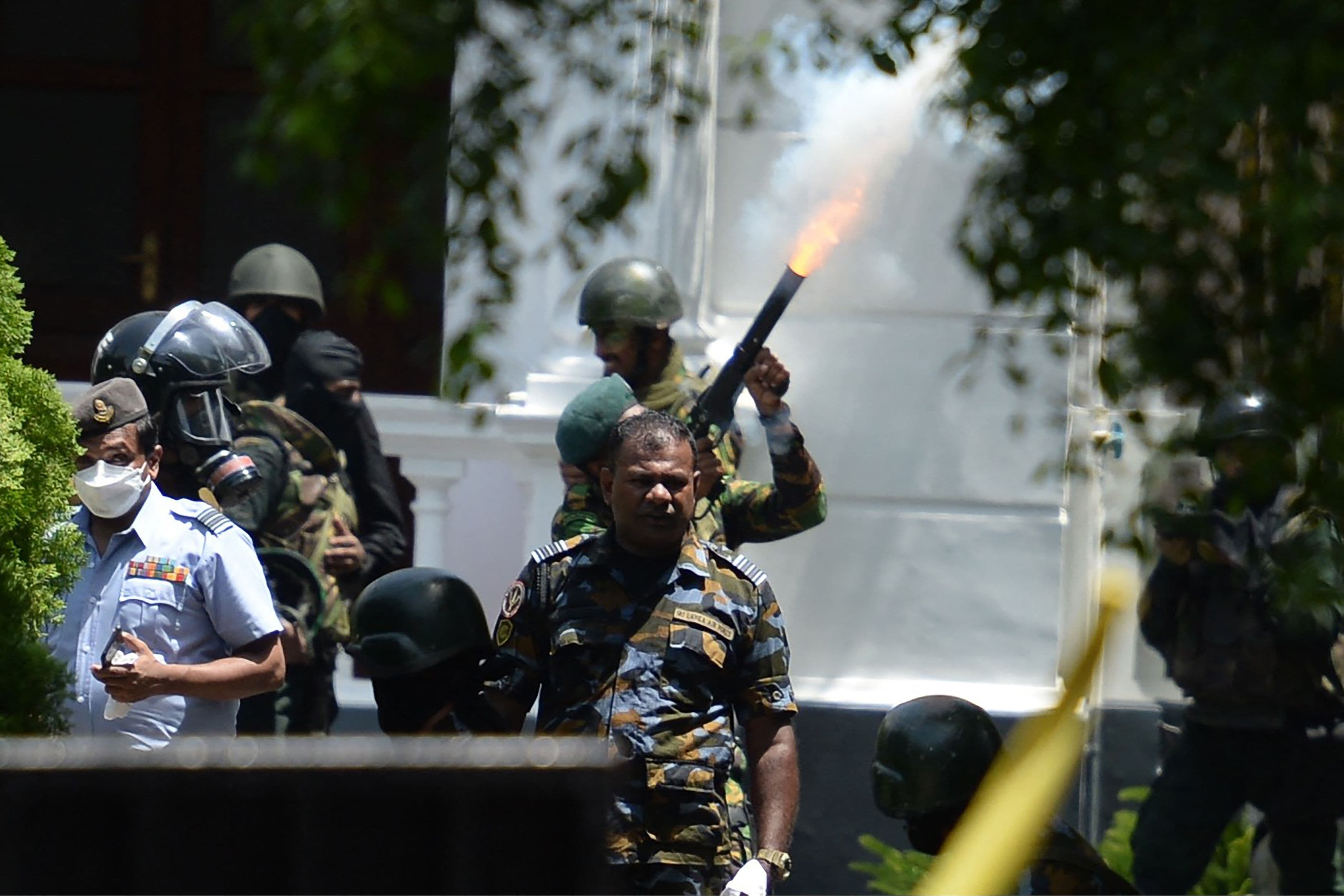 Sri Lanka crisis: An army personnel fires a tear gas canister to disperse demonstrators during an anti-government protest outside the office of Sri Lanka's prime minister in Colombo. (AFP) Sri Lanka crisis: An army personnel fires a tear gas canister to disperse demonstrators during an anti-government protest outside the office of Sri Lanka's prime minister in Colombo. (AFP)