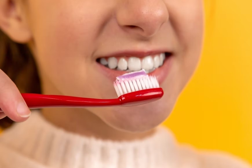 Although healthy gums are usually pinkish in colour, in some people, they may be slightly darker (Unsplash)