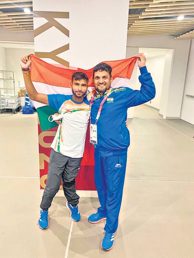 Praveen Kumar with his coach, Satpal Singh.