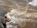  A fisherman casts his net in the Krishna river in Karad, Maharashtra. A fisherman casts his net in the Krishna river in Karad, Maharashtra.