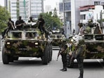 Sri Lankan Army on board armored carriers patrolling main routes in Colombo to maintain law and order.