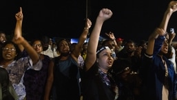 Demonstrators cheer after hearing news that Gotabaya Rajapaksa, Sri Lanka's president, emailed a letter of resignation, at a protest site close to the president's office in Colombo, Sri Lanka, on Thursday, July 14, 2022. (Buddhika Weerasinghe/Bloomberg)