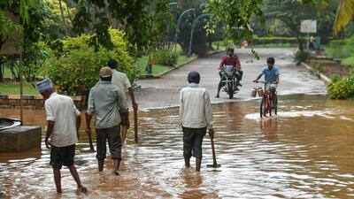 The tally of missing persons amid heavy rainfall across Karnataka rose to five on Thursday after two persons were washed away in separate incidents, and a rescue operation to locate them remained unsuccessful so far. (AFP) The tally of missing persons amid heavy rainfall across Karnataka rose to five on Thursday after two persons were washed away in separate incidents, and a rescue operation to locate them remained unsuccessful so far. (AFP)