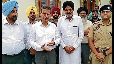 Punjab director general of police (DGP) Gaurav Yadav with slain singer Sidhu Moose Wala’s father at Moosa village in Mansa on Thursday. (HT Photo)