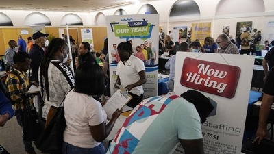 The number of unemployed also fell by an unusually large 54,300, while layoffs were limited. (AP FILE - Job applicants fill out forms.)