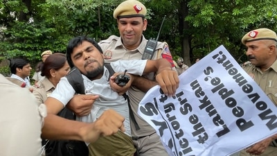 Delhi police detain a youth who was protesting expressing solidarity with Sri Lankan protestors outside Sri Lankan High Commission in New Delhi (AP) Delhi police detain a youth who was protesting expressing solidarity with Sri Lankan protestors outside Sri Lankan High Commission in New Delhi (AP)