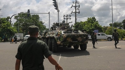 Sri Lankan army soldiers stand guard near the parliament building in Colombo on Thursday. (AFP)