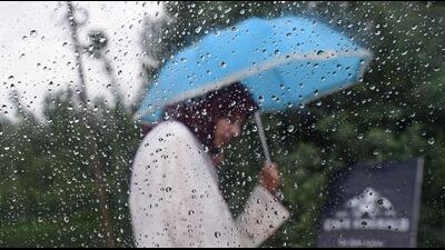 A woman walks with an umbrella on a rainy day in Srinagar. (Waseem Andrabi/Hindustan Times) A woman walks with an umbrella on a rainy day in Srinagar. (Waseem Andrabi/Hindustan Times)
