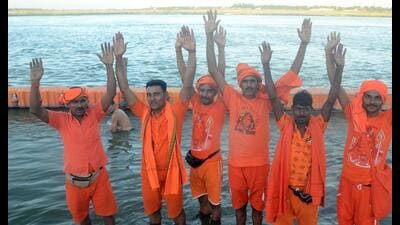 Kanwariyas at a ghat in Prayagraj before heading to Varanasi on Thursday. (HT Photo)