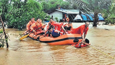 National Disaster Response Force (NDRF) personnel conduct a rescue operation to save stranded locals from the flood-hit Chikhli town following heavy monsoon rains, in Gujarat’s Navsari district on Thursday. (PTI) National Disaster Response Force (NDRF) personnel conduct a rescue operation to save stranded locals from the flood-hit Chikhli town following heavy monsoon rains, in Gujarat’s Navsari district on Thursday. (PTI)