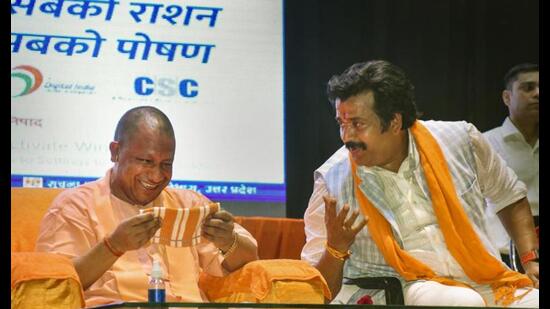 Uttar Pradesh chief minister Yogi Adityanath interacts with BJP leader Ravi Kishan during an event, in Gorakhpur, Thursday. (PTI Photo)