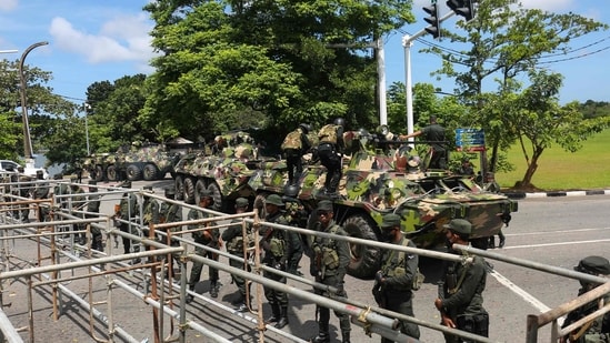 Sri Lanka army soldiers stand guard near the parliament building in Colombo on Thursday.
