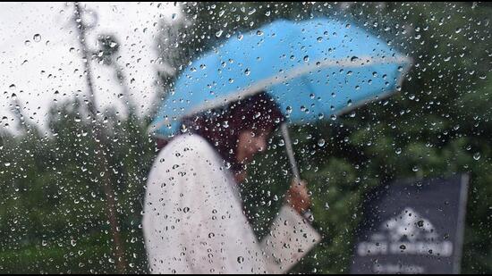 A woman walks with an umbrella on a rainy day in Srinagar. (Waseem Andrabi/Hindustan Times) A woman walks with an umbrella on a rainy day in Srinagar. (Waseem Andrabi/Hindustan Times)
