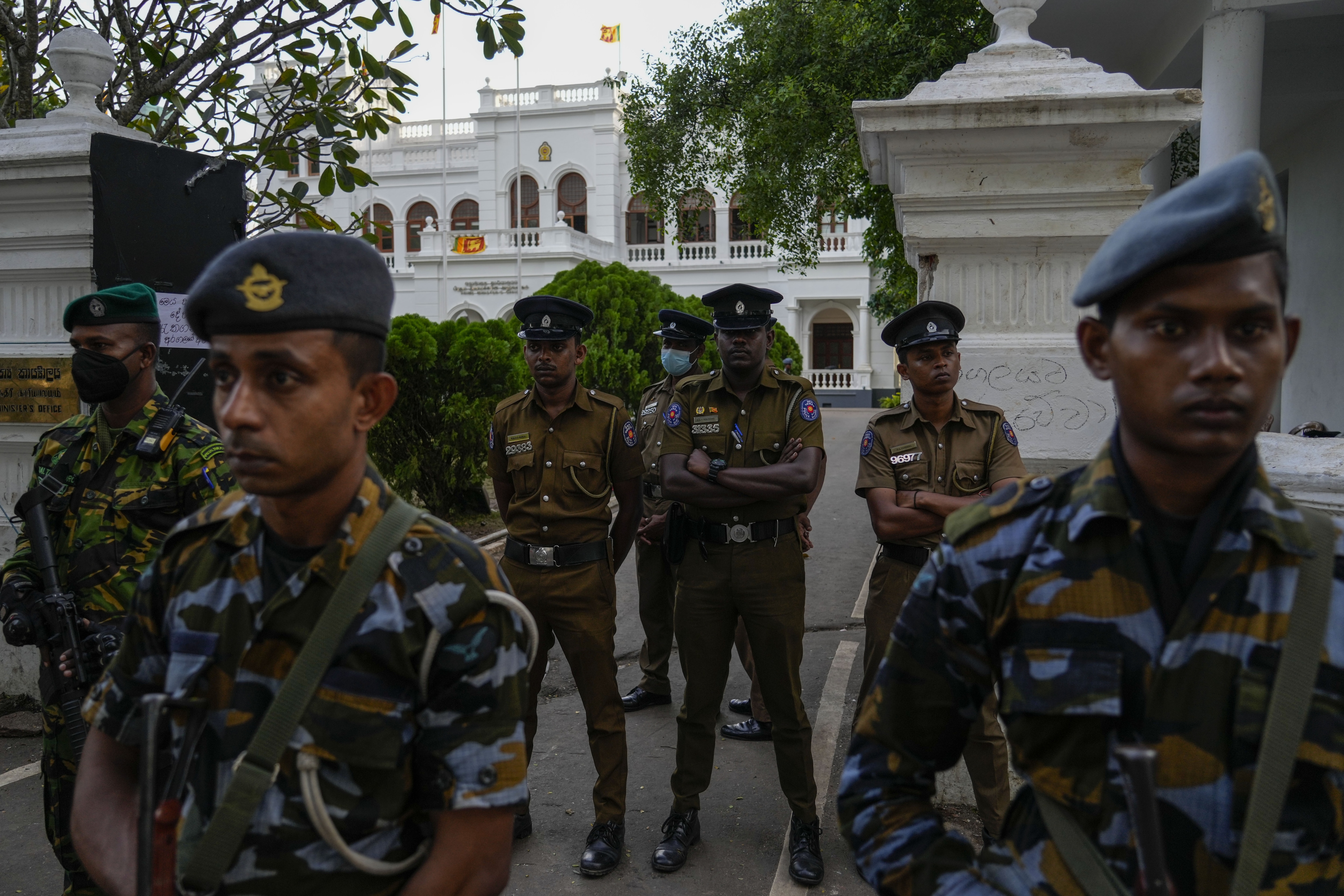 Army and police stand guard as protesters leave prime minister Ranil Wickremesinghe's office building in Colombo. (AP) Army and police stand guard as protesters leave prime minister Ranil Wickremesinghe's office building in Colombo. (AP)