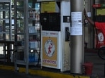 A worker stands at an empty fuel station in Colombo on Thursday.&nbsp;