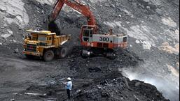 Workers use heavy machinery to shift a pile of coal at an open cast mine in India. (AFP File Photo)