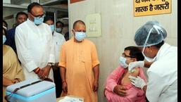 •A healthcare worker administers a booster shot of Covid-19 vaccine to a beneficiary in the presence of UP CM Yogi Adityanath during the launch of a 75-day special drive for free vaccination against Covid-19, at Civil Hospital in Lucknow on Friday. (ANI Photo/UP CMO Twitter)