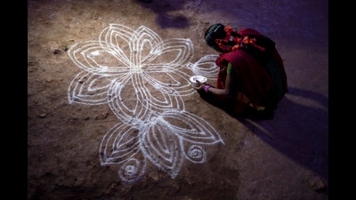 A girl drawing a kolam in front of her house in Krishnagiri, Tamil Nadu. (Reza/Getty Images) A girl drawing a kolam in front of her house in Krishnagiri, Tamil Nadu. (Reza/Getty Images)