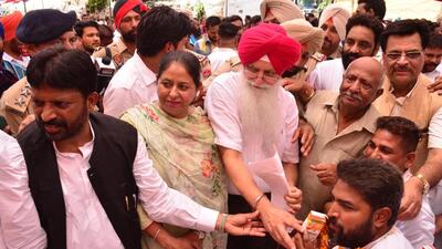 Cabinet Minister Inderbir Singh Nijjar offering juice to employees to end the hunger strike in Ludhiana. (HT PHOTO)