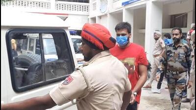 Punjab Police taking the shooter Ankit Sirsa, 19, to court in Mansa on Friday. (HT Photo) Punjab Police taking the shooter Ankit Sirsa, 19, to court in Mansa on Friday. (HT Photo)