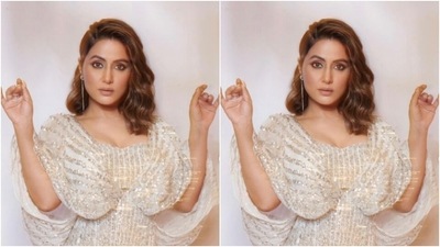 Hina wore an off-white gown that came intricately detailed in silver resham threads and decorations. The gown featured a sweetheart neckline and cascaded with bodycon details to her feet. (Instagram/@realhinakhan)