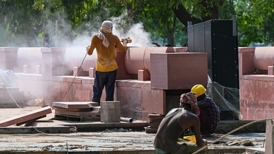Labourers cut stone blocks during the construction work under the Central Vista project at Rajpath in New Delhi. (AFP) Labourers cut stone blocks during the construction work under the Central Vista project at Rajpath in New Delhi. (AFP)