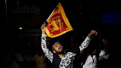 A man holds up &nbsp;Sri Lankan flag out of joy.&nbsp; (REUTERS)