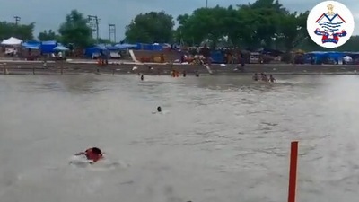 The image, taken from the Twitter video, shows the Uttarakhand cops saving drowning youth in Haridwar. (Twitter/@uttarakhandcops)