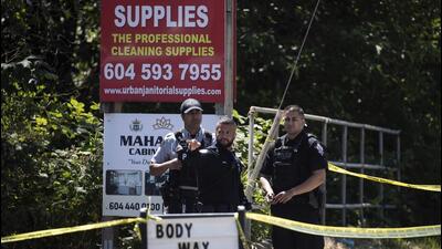 Surrey Police officers and an RCMP officer work at the scene of a shooting in Surrey, British Columbia, Canada, on Thursday. (AP) Surrey Police officers and an RCMP officer work at the scene of a shooting in Surrey, British Columbia, Canada, on Thursday. (AP)