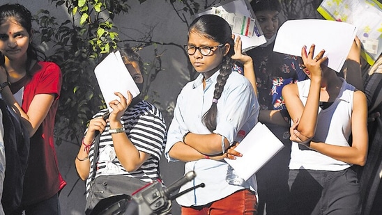 Students arrive to appear for the first slot of CUET-UG at North Campus in New Delhi.