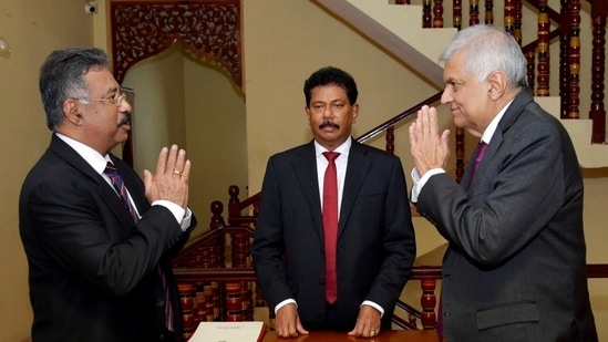 Sri Lankan President's Office, interim President Ranil Wickremesinghe, right, greets Chief Justice Jayantha Jayasuriya during the oath-taking ceremony in Colombo, Sri Lanka.(AP)